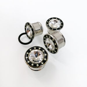 Ear plugs with Large faux crystal and stars. Surgical Steel ear gauges. Unisex ear plugs. 18mm, 16mm, 14mm. Black and silver