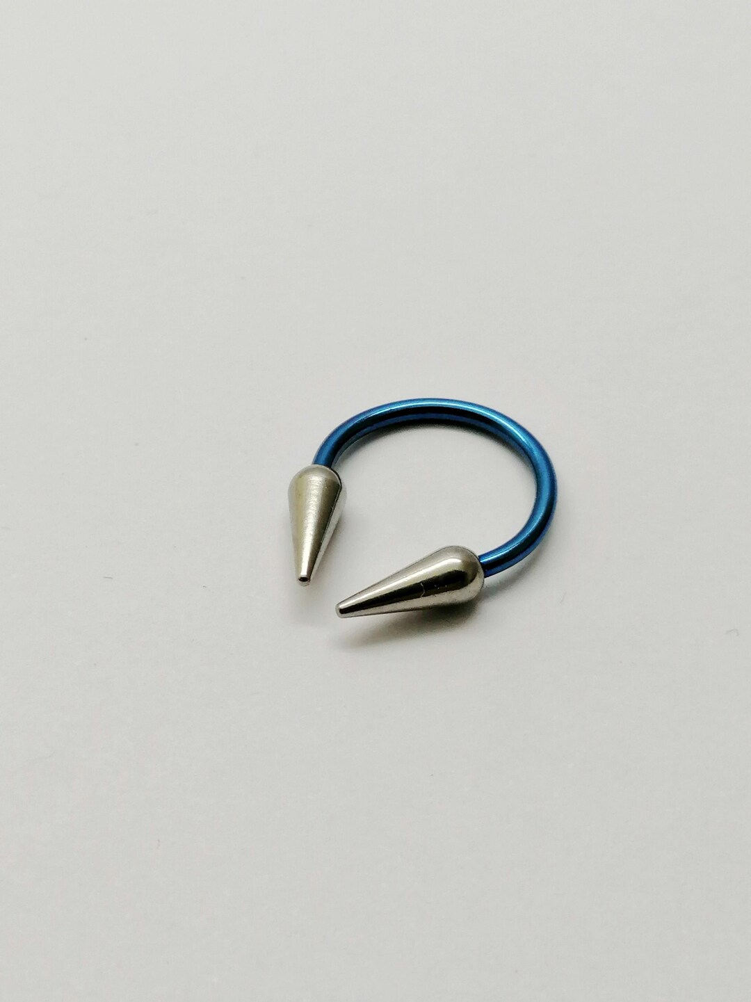 Nickel Free Circular Barbell Blue Color 2 Spikes Cones. Hypoallergenic