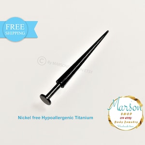 May include: Black titanium body jewellery piercing with a pointed end. The piercing is nickel free and hypoallergenic. The text "Nickel free Hypoallergenic Titanium" is visible in the image. The image also includes a logo with the text "Marson Shop on Etsy Body Jewellery Handmade Items".