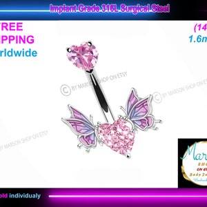 May include: A pink crystal heart with butterfly wings on either side, attached to a surgical steel belly button ring. The ring is 1.6 mm thick and 14 gauge. The text "Implant Grade 316L Surgical Steel" is at the top of the image. The text "(14g) 1.6mm" is at the top right of the image. The text "FREE SHIPPING Worldwide" is at the top left of the image. The text "Sold individually" is at the bottom of the image.