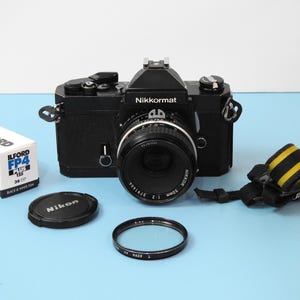 Black Nikkormat FT3 Nikon SLR Film Camera + Nikkor 50mm f 2.0 lens + 1 Rolls of film + New light seals Shipping Via UPS