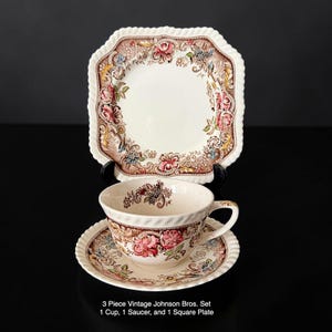 May include: A vintage Johnson Bros. tea set featuring a cup, saucer, and square plate. The set has a cream-colored base with floral and foliage patterns in pink, brown, and blue. The edges have a rope-like trim. The text on the image reads: 3 Piece Vintage Johnson Bros. Set 1 Cup, 1 Saucer, and 1 Square Plate.