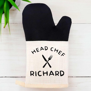 May include: Black and white oven mitt with the text "Head Chef Richard" and a crossed knife and fork graphic.