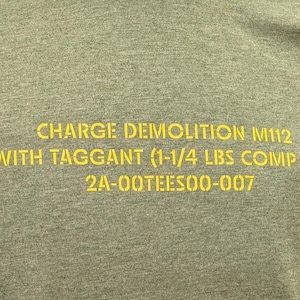 May include: Green t-shirt with yellow text that reads "CHARGE DEMOLITION M112 WITH TAGGANT (1-1/4 LBS COMP C-4) 2A-OOTEES00-007" and "2Atees.com" at the bottom.