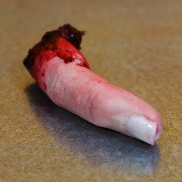Bloody severed finger. Halloween decoration, pranks or horror prop
