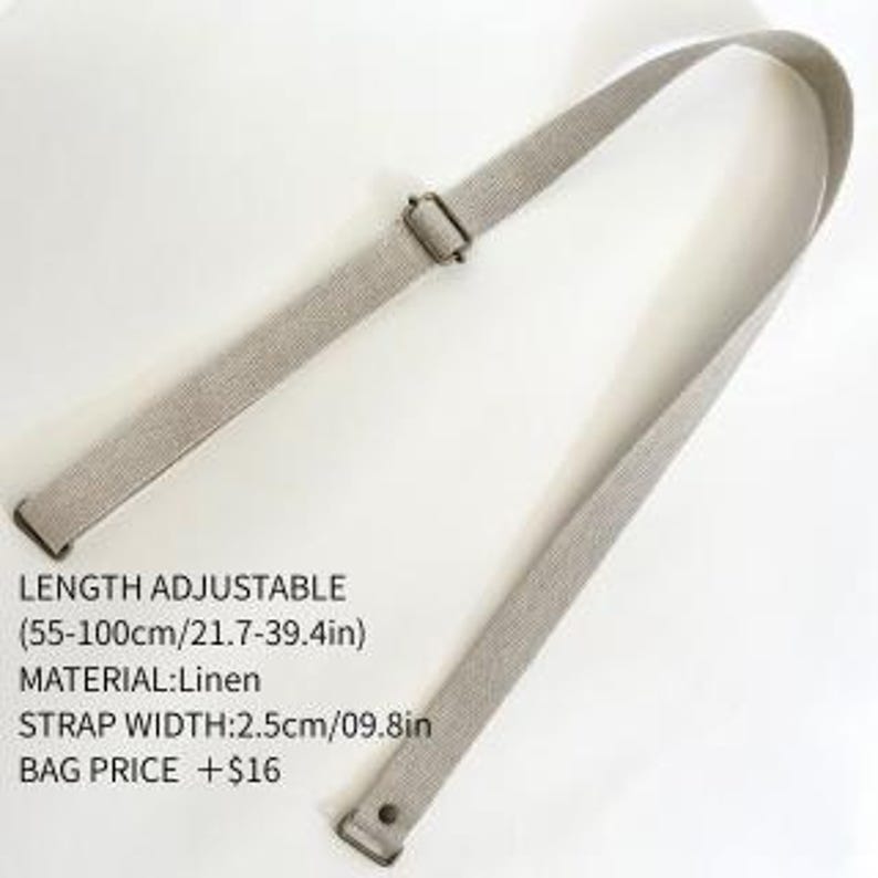 May include: A beige linen bag strap with a metal slider for length adjustment. The strap is adjustable from 21.7 to 39.4 inches in length and has a width of 0.98 inches. The strap features metal hardware at both ends for attachment.