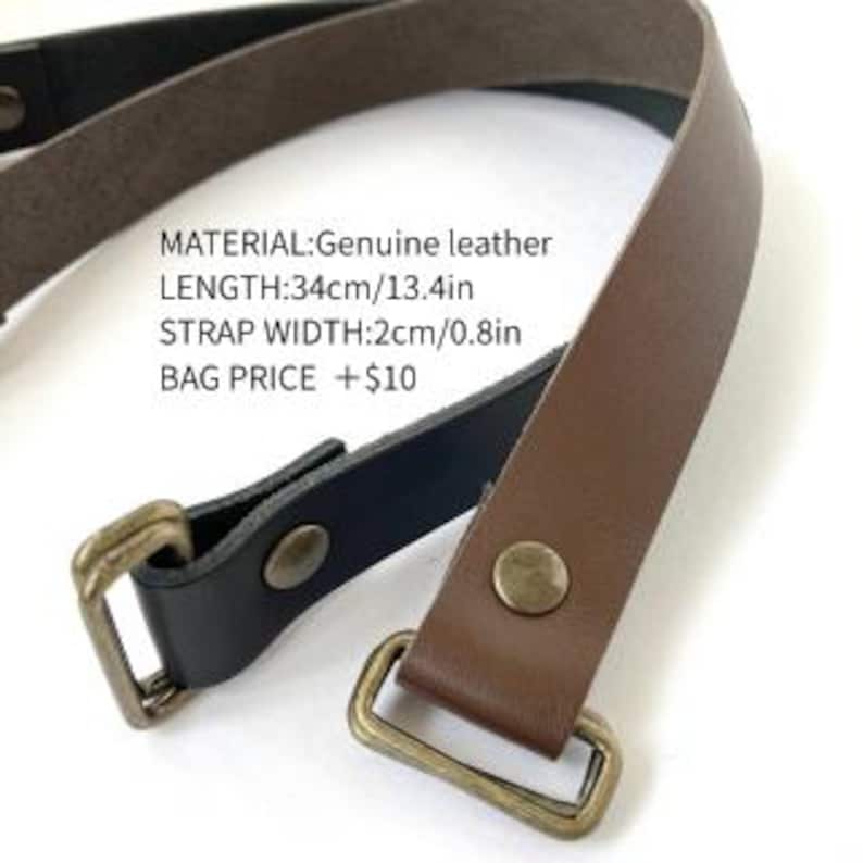 May include: A brown and black leather strap featuring brass-toned metal hardware and rivets. The text on the image reads: MATERIAL:Genuine leather, LENGTH:34cm/13.4in, STRAP WIDTH:2cm/0.8in, BAG PRICE +$10. The strap is designed with rectangular loops.