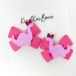 Dinosaur bows, pink dinosaurs, dinosaur birthday, dinosaurs, pastel dinosaurs, stegosaurus, pink pigtail bows, dino hair bows, dino party