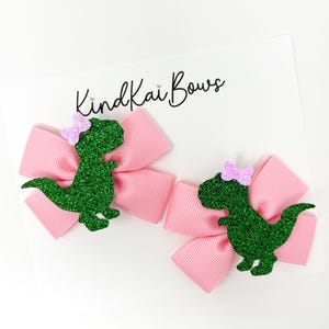 Dinosaur bows, pink dinosaurs, dinosaur birthday, dinosaurs, pastel dinosaurs, stegosaurus, green pigtail bows, dino hair bows, dino party