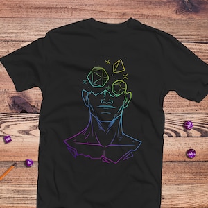 May include: Black t-shirt with a rainbow-colored graphic of a person's head with dice inside. The dice are different shapes and sizes.