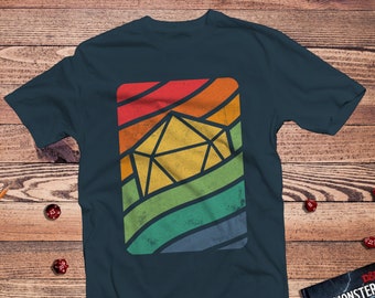 May include: A dark blue t-shirt featuring a rainbow-coloured graphic of a twenty-sided die. The graphic has a vintage, distressed look.