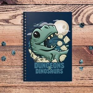May include: A blue spiral notebook with a cartoon dinosaur and dice. The notebook has the text "Dungeons & Dinosaurs" on the front.