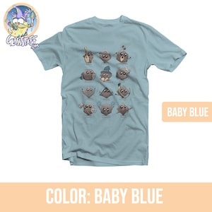 May include: A light blue t-shirt with a graphic of dice representing different Dungeons and Dragons character classes. The classes are: Bard, Fighter, Barbarian, Paladin, Wizard, Druid, Sorcerer, Rogue, Cleric, Warlocks, and Monk.