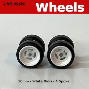 May include: Two 10mm white rim wheels with 4 spokes and black tires. 1:64 Scale Wheels.