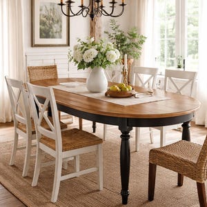 Handmade farmhouse oval dining table styled in a warm farmhouse dining room with soft natural light and classic chairs.