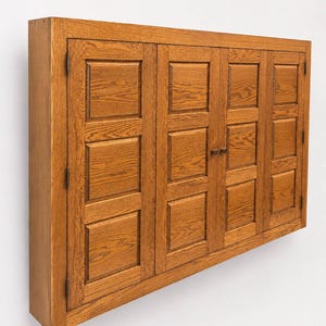 Three-quarter view of solid oak TV hideaway cabinet designed to conceal flat-screen televisions.