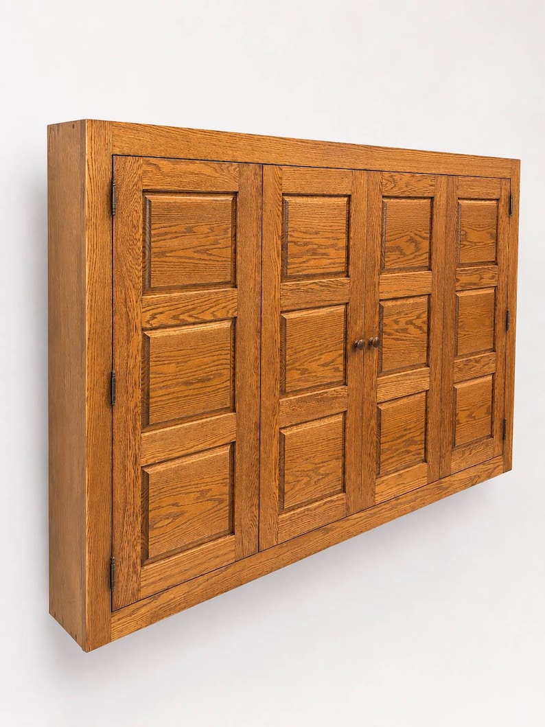 Three-quarter view of solid oak TV hideaway cabinet designed to conceal flat-screen televisions.