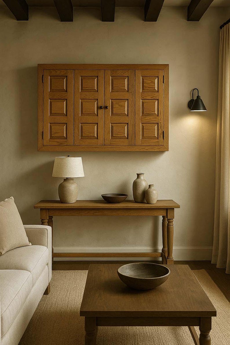 Phoenix TV Wall Cabinet styled in a rustic farmhouse living room, mounted above a wooden console table with pottery décor, neutral tones, and warm lighting.