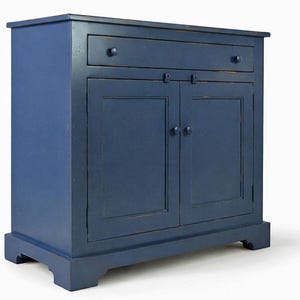 Handcrafted farmhouse buffet cabinet showing side profile and traditional bracket feet.