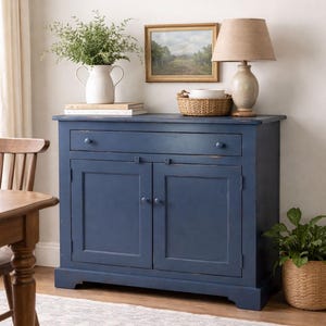 Handmade farmhouse buffet cabinet styled in rustic dining room interior with cottage decor.