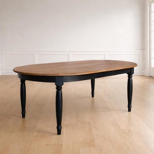 Handcrafted oval farmhouse dining table shown alone in a refined farmhouse dining room, highlighting its silhouette and solid wood construction.