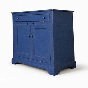Side view of blue farmhouse buffet cabinet with two doors and one drawer