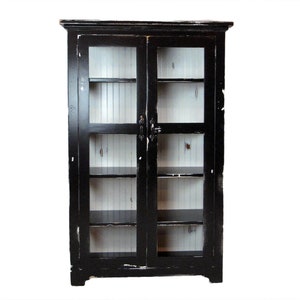 May include: Black wooden cabinet with glass doors and shelves. The cabinet has a distressed finish and is perfect for displaying items.