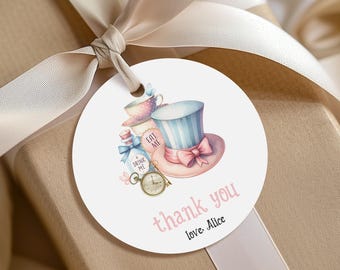 May include: White round thank you tag with a watercolor illustration of a Mad Hatter's hat, a bottle with "Drink Me" label, a pocket watch, and a teacup. The text "thank you" and "Love, Alice" is printed in pink.