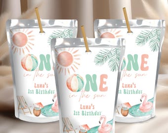 May include: Three white pouches with a beach theme, each featuring a sun, beach ball, and flamingo pool float. Text reads "ONE in the sun" and "Luna's 1st Birthday". Each pouch has a straw.