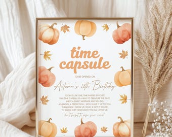 Könnte beinhalten: Gerahmter Druck mit goldenem Rahmen, mit Aquarellkürbissen und Blättern. Der Text lautet "Zeitkapsel" und "Autumns 18. Geburtstag". Der Druck ist zum späteren Öffnen gedacht, mit Platz für Nachrichten.