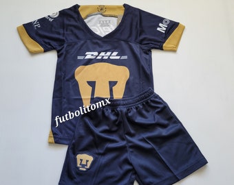 May include: A blue and gold soccer jersey and shorts set with a puma logo. The jersey has the text "DHL" on the front. The shorts have a puma logo on the left leg.