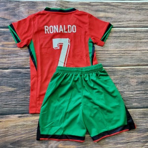 May include: Red and green soccer jersey with the name "RONALDO" and the number "7" on the back. Matching green soccer shorts with black trim.
