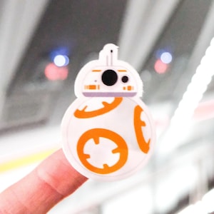 May include: A white and orange BB-8 Star Wars character sticker.