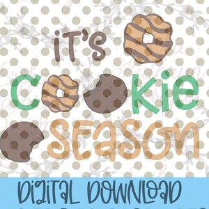 May include: It's cookie season graphic with a green "C" and a brown cookie with stripes, a brown cookie with a bite taken out of it, and a brown cookie with a bite taken out of it. The text is in a brown, orange, and green font.