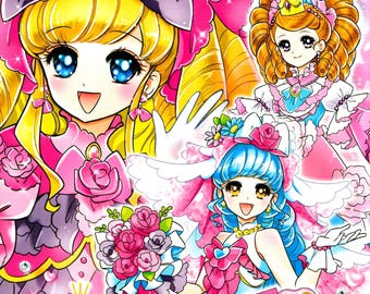 May include: A colouring book featuring two anime girls in pink and blue dresses. The cover has the text "オシャレ ドレスコレクション ぬりえ" which translates to "Stylish Dress Collection Colouring Book".