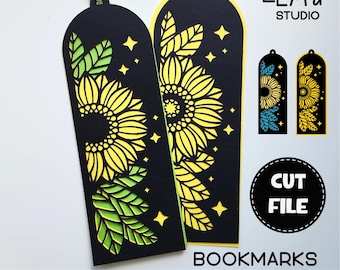 May include: Two black bookmarks with a sunflower and leaf design cut out. The bookmarks are on a white background with the text "SVG DXF PNG" and "BOOKMARKS" below them. The text "CUT FILE" is in a circle above the bookmarks.