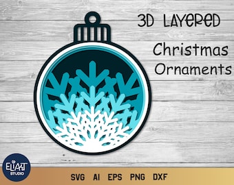 Op de afbeelding: Een gelaagd kerstornamentontwerp met een sneeuwvlokpatroon. Het ornament is in tinten blauw en wit, met de tekst "3D Layered Christmas Ornaments" erboven. Het ontwerp bevat SVG-, AI-, EPS-, PNG- en DXF-bestandsformaten.