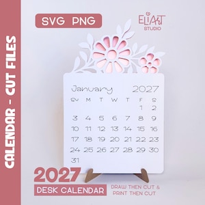 May include: A white desk calendar for January 2027 featuring a laser-cut floral topper with pink accents. The calendar displays the month, year, and days of the week in black text. It is supported by a small stand and includes SVG and PNG labels.