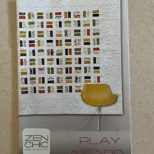 May include: A brochure with the text "ZEN CHIC" and "PLAY A CARD". The cover features a quilt design with rectangular blocks in various colors and a yellow chair.