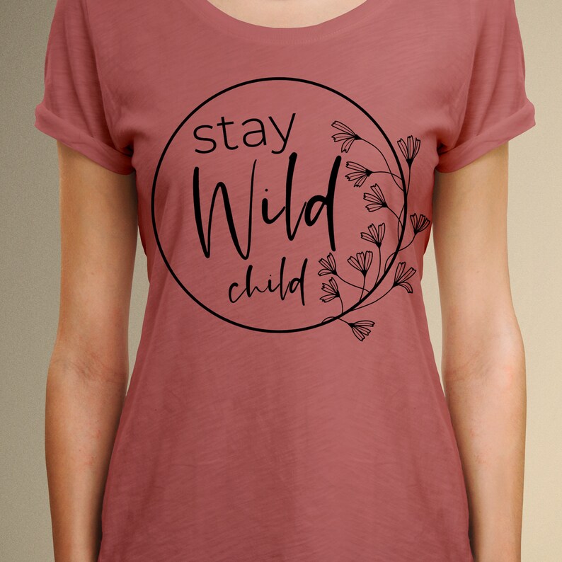 May include: A maroon t-shirt with a black circle graphic that says "stay wild child" with a floral design.
