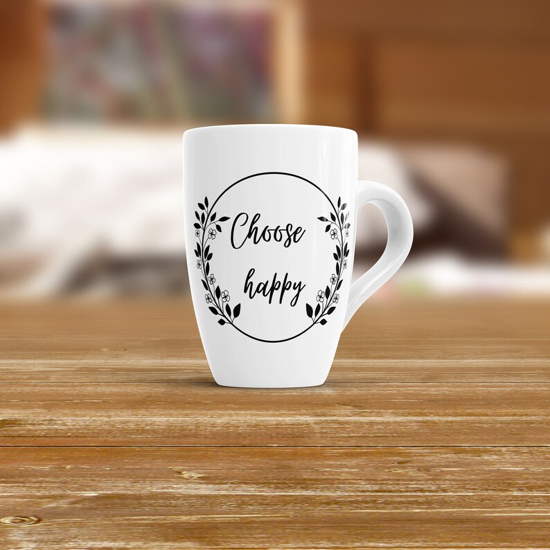 May include: White ceramic mug with a black circle and the text "Choose happy" surrounded by a floral wreath.