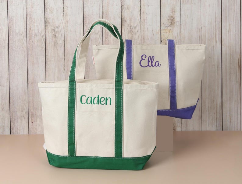 Personalized canvas tote bag with embroidered name, contrasting trim and zip-top closure, designed for travel, everyday use and personalized gifts for her.