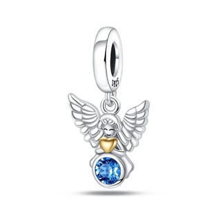 May include: A silver charm with an angel design. The angel has detailed wings, a gold heart, and a blue gemstone. The charm is suspended from a silver loop, marked with "S925".