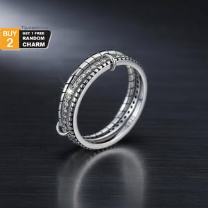 Pierścionek ze srebra próby 925 z potrójnym splotem – lśniąca, składana obrączka z wysadzanymi kamieniami