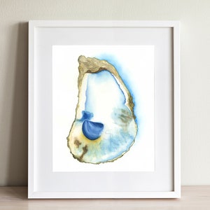 May include: Watercolor painting of an oyster shell in a white frame. The shell is depicted with shades of blue, gold, and brown. The artwork is displayed against a light background, enhancing the colors of the shell.