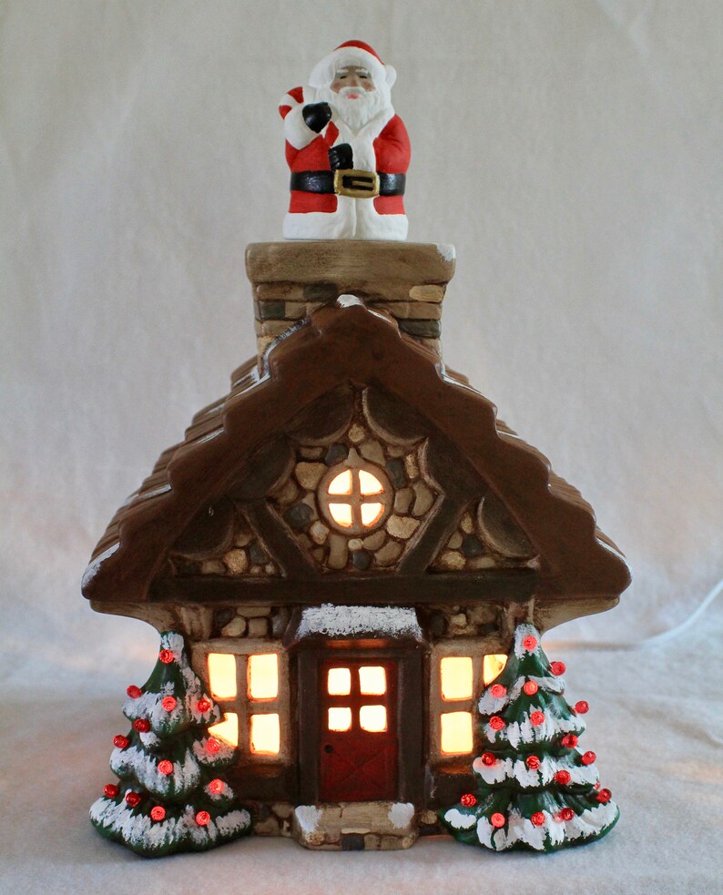 Realistic ceramic cabin-style house with decorated trees
