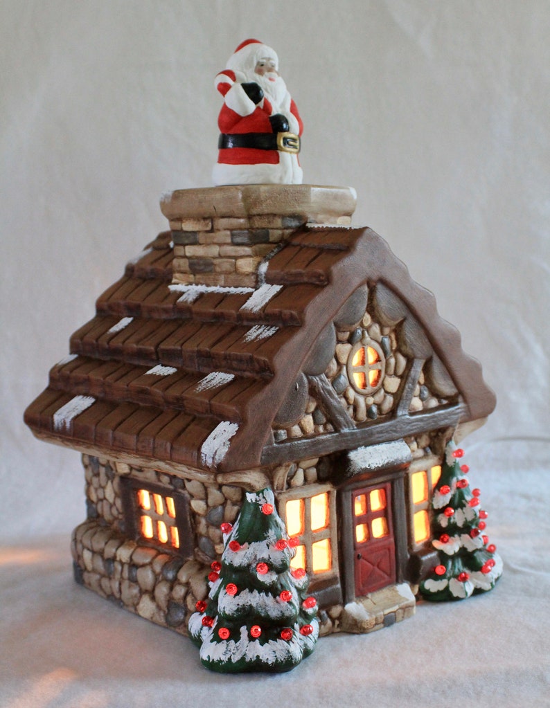 Realistic ceramic cabin-style house with decorated trees
