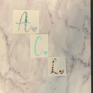 Initial decal with heart.