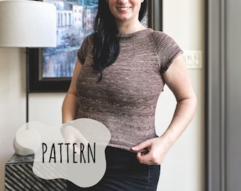 May include: A woman wearing a brown knit top with a subtle pattern. The top has a scoop neck and short sleeves. The word "PATTERN" is written in white on a gray background in the lower left corner of the image.