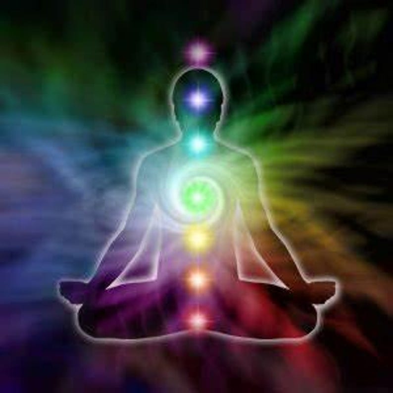 May include: A silhouette of a person in a seated meditation pose against a swirling, multicolored background. Seven glowing, vertically aligned points of light in violet, indigo, blue, green, yellow, orange, and red represent energy centers.